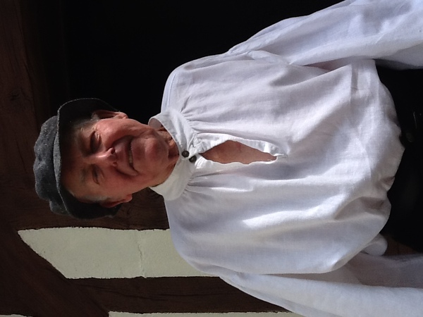 Man wearing a smock and hat